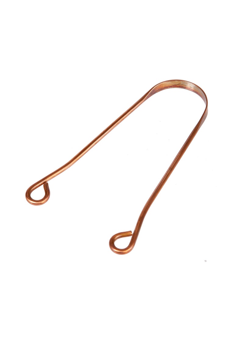 May include: A copper tongue scraper with two rounded ends. The scraper is designed to remove bacteria and debris from the tongue.