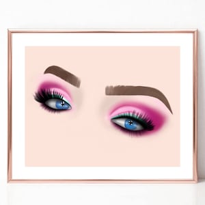 May include: A framed print featuring a close-up of two stylized eyes. The eyes are blue with long black eyelashes and vibrant pink eyeshadow. The eyebrows are a medium brown, and the background is a soft peach color.