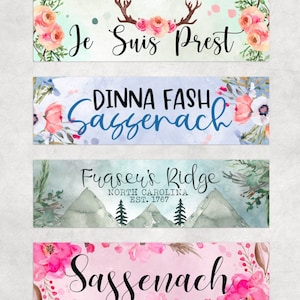 May include: Four watercolour-style banners with floral and mountain designs. The first banner has a floral design with the text "Je Suis Prest". The second banner has a floral design with the text "Dinna Fash Sassenach". The third banner has a mountain design with the text "Fraser's Ridge North Carolina Est. 1767". The fourth banner has a floral design with the text "Sassenach".
