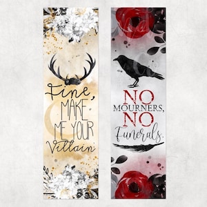 May include: Two bookmarks with watercolor floral designs. The left bookmark features a stag silhouette with the text "Fine, make me your villain". The right bookmark features a raven silhouette with the text "No mourners, no funerals."