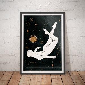 May include: Framed art print featuring a white silhouette of a person floating in space against a black background. Gold stars, constellations, and a sunburst design add celestial details. The artwork is displayed in a black frame.