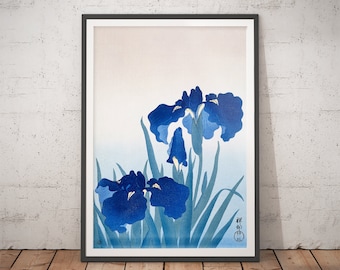 May include: A framed print of a Japanese woodblock print featuring blue irises with green leaves against a light blue and pink background. The print is signed in Japanese characters.