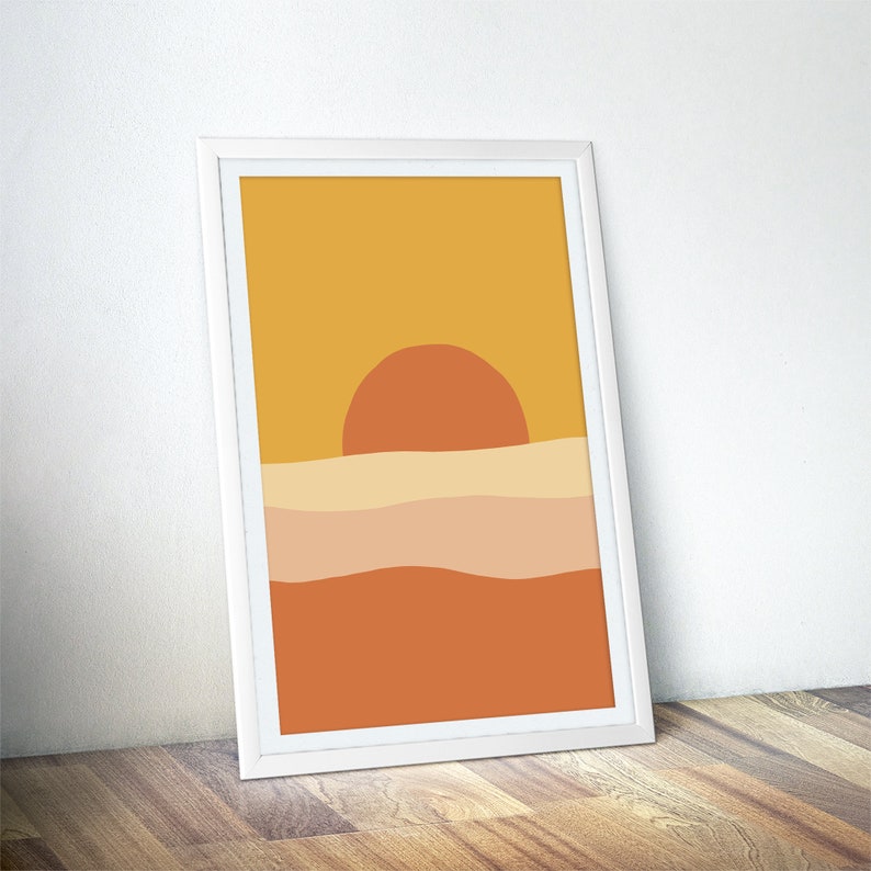May include: Abstract sunset art print with a yellow, orange, and brown color scheme. The print features a large orange sun setting over a series of wavy lines.