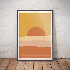 May include: A framed abstract print with a yellow background, a large orange sun, and wavy lines in shades of orange and beige.
