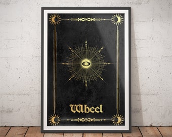 May include: A black and gold poster featuring a stylised eye within a circular design. The poster has a gold border and the word "Wheel" in gold lettering.