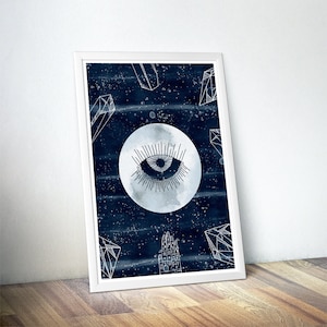 May include: A white framed print with a dark blue background featuring a white stylized eye inside a moon with white geometric shapes around it.
