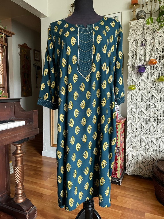 Teal tunic with brass pattern