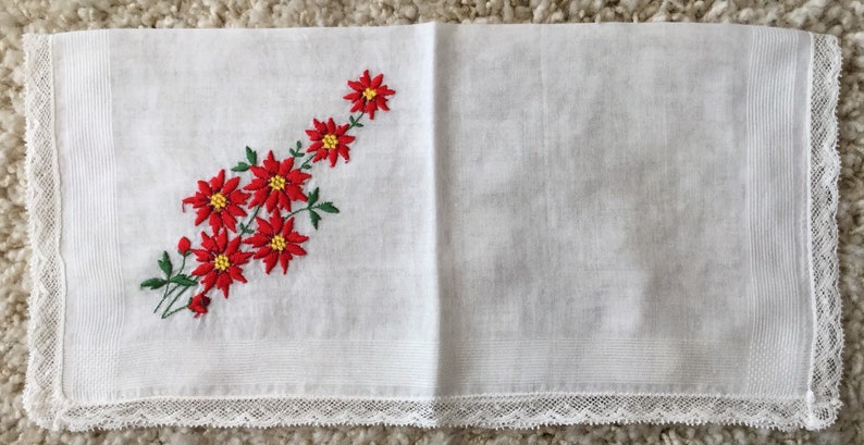 Vintage 1960s white cotton floral Christmas handkerchief embroidered red poinsettias greenery lace edging retro kitschy Xmas hankie