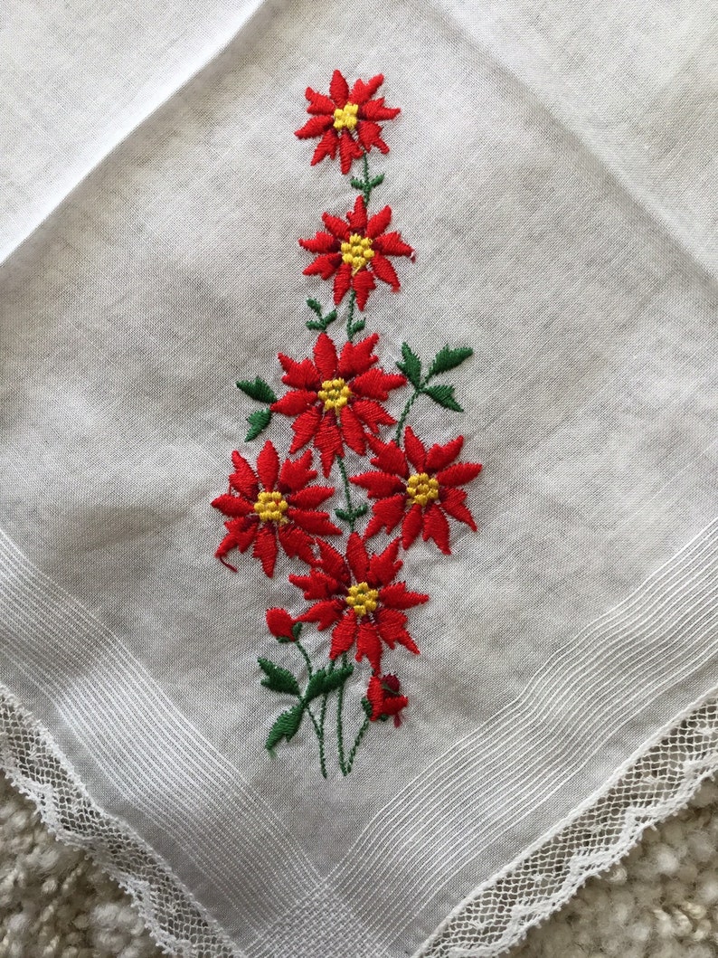 Vintage 1960s white cotton floral Christmas handkerchief embroidered red poinsettias greenery lace edging retro kitschy Xmas hankie