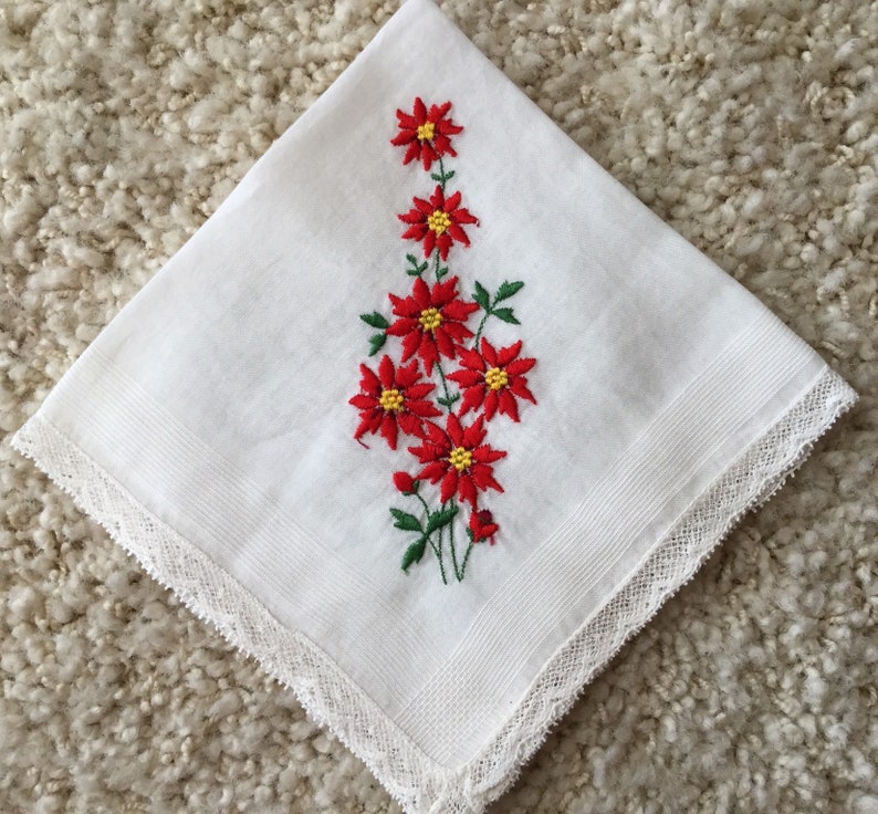 Vintage 1960s white cotton floral Christmas handkerchief embroidered red poinsettias greenery lace edging retro kitschy Xmas hankie