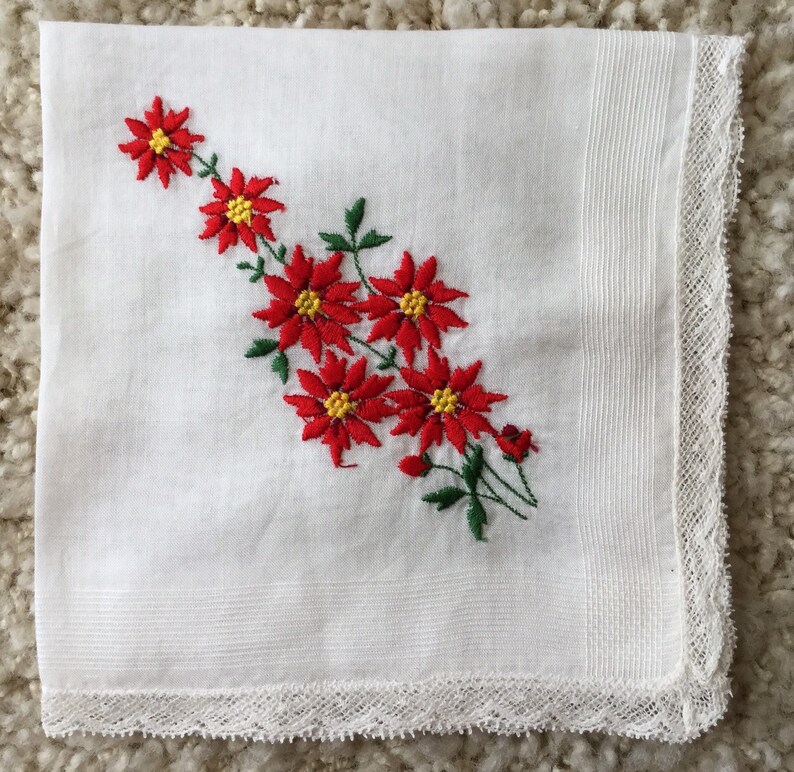 Vintage 1960s white cotton floral Christmas handkerchief embroidered red poinsettias greenery lace edging retro kitschy Xmas hankie