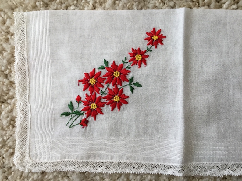 Vintage 1960s white cotton floral Christmas handkerchief embroidered red poinsettias greenery lace edging retro kitschy Xmas hankie