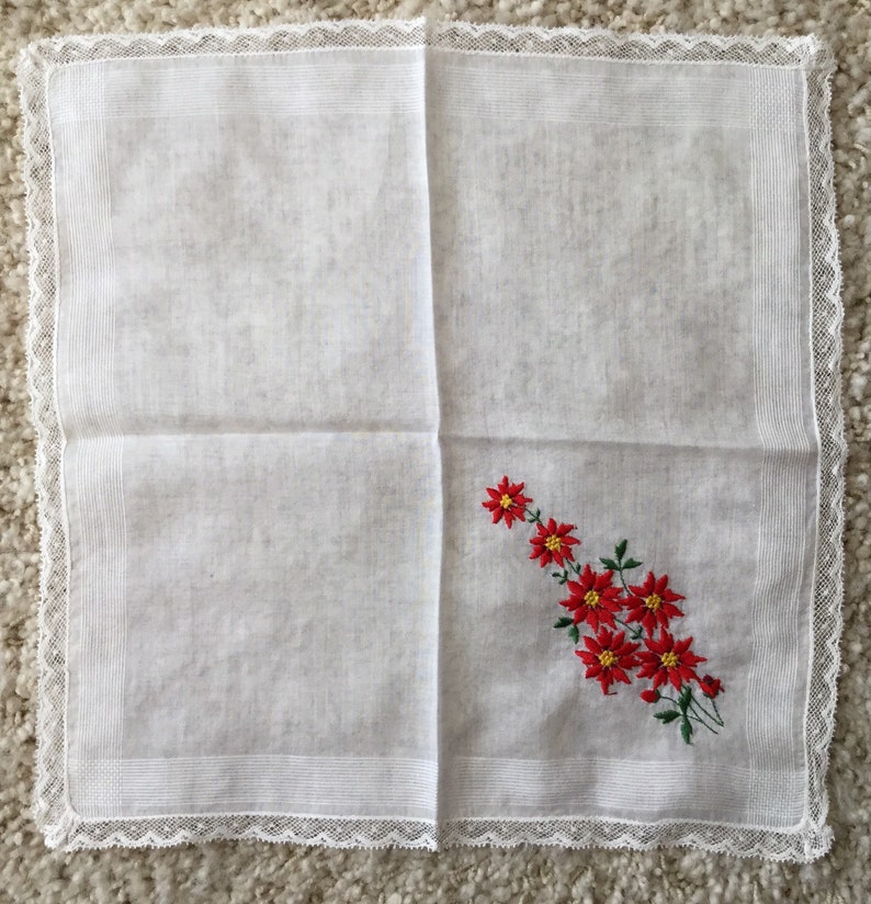 Vintage 1960s white cotton floral Christmas handkerchief embroidered red poinsettias greenery lace edging retro kitschy Xmas hankie