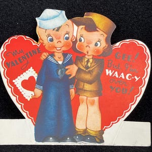 May include: A vintage Valentine's Day card featuring a cartoon sailor and a cartoon soldier. The card is shaped like a heart and has the text "My Valentine" and "GEE! But I'm WAAC-Y over you!"