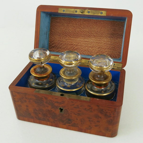 PERFUME BOTTLES CASKET - 19th century inlaid amboina and rosewood monogramed box with three crystal bottles from France