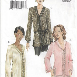 May include: Vogue sewing pattern number 7780 for a blouse with a V-neck and long sleeves. The pattern includes three different styles: a paisley print blouse, a striped blouse, and a solid pink blouse.