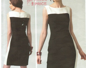 May include: A black and white color block dress pattern by Kay Unger. The sleeveless dress features a white neckline and side panels. The pattern includes the text "V1329" and "VOGUE PATTERNS AMERICAN DESIGNER".