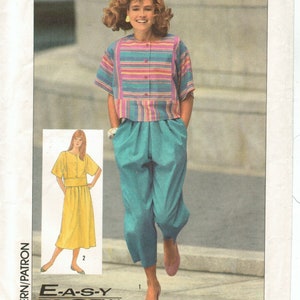 May include: Simplicity sewing pattern 7322. The image shows a woman wearing a striped top and teal pants. The pattern includes a yellow dress design. The text "EASY TO SEW" is visible.