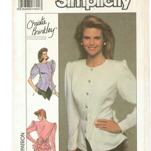 May include: Simplicity sewing pattern number 8940, size 14, for a white blouse with a button-up front and puffed sleeves. The pattern is from the Christie Brinkley Collection.