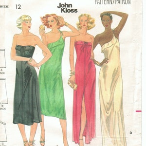 May include: A vintage sewing pattern for four different styles of dresses. The pattern is for size 12 and is called "Butterick 5704". The dresses are all sleeveless and have a one-shoulder design. The dresses are shown in black, green, pink, and white.