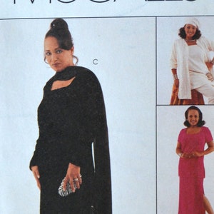 May include: McCall's sewing pattern featuring a woman in a black outfit, with additional outfit options in white, pink, and light blue. The pattern includes the text "Easy McCall's", the number "9125", and the signature "Daphne Maxwell Reid".
