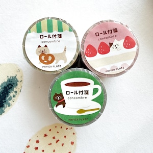 May include: Three rolls of decorative tape with Japanese text and cute illustrations. One roll features a cat with a pretzel, another has a cat with strawberries, and the last shows a cat with coffee. The brand name "PAPIER PLATZ" is printed on each roll.