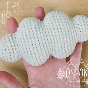 May include: A crocheted cloud pattern, in white yarn, with the text "PATTERN ONLY" above it and "ONPOKI Handmade stuff" below it.