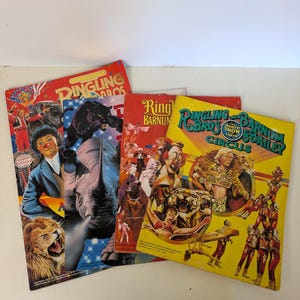 May include: A collection of four vintage Ringling Bros. and Barnum & Bailey circus programs. The covers feature colorful illustrations of clowns, lions, rhinos, panthers, and acrobats, with bold text including The Greatest Show on Earth.