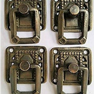 May include: Four antique bronze-toned drawer pulls. Each pull has a square backplate with decorative detailing and a rectangular handle. The pulls are designed with a vintage aesthetic, suitable for furniture restoration or adding a classic touch to cabinetry.