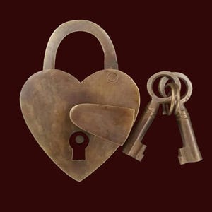 May include: A heart-shaped brass padlock with two antique keys. The padlock has a keyhole and a latch. The keys are attached to a ring.