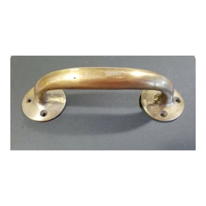 May include: A brass door handle with a curved design and two round plates. The handle is a traditional style and would be suitable for a variety of doors.