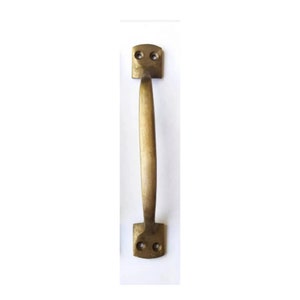 May include: A brass door pull handle with a rounded rectangular shape. The handle has a smooth, slightly curved design and two holes for mounting.