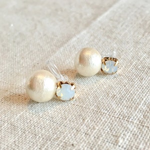 May include: A pair of pearl and rhinestone clip-on earrings. The earrings feature a white pearl and a clear rhinestone.