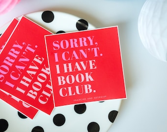 May include: Red square stickers with the text "SORRY, I CAN'T. I HAVE BOOK CLUB." in pink and white. The stickers are on a white plate with black polka dots. The stickers are from Francine and Georgia.