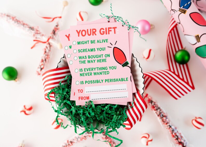 May include: Pink gift tags with a green lightbulb graphic and the text "Your Gift: Might be alive, screams you! Was bought on the way here, is everything you never wanted, is possibly perishable."  The tags have blank spaces for "To" and "From".