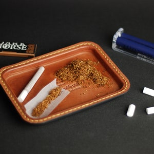 Leather tray for cigarettes.