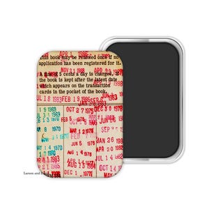 May include: A rectangular magnet with rounded corners featuring a vintage library card design. The card has red stamped dates and text, including "APR 1 1986" and "NOV 21 1988". The magnet is next to a black rectangular shape.