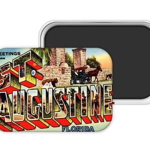 May include: A rectangular magnet featuring a vintage postcard design with the text "Greetings from St. Augustine Florida." The image includes a horse-drawn carriage, buildings, and the city name in bold, 3D letters with red and yellow accents.