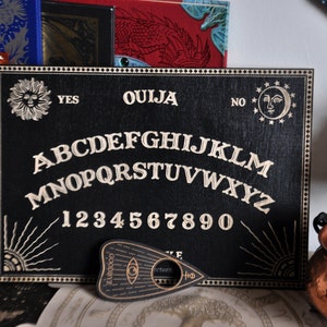 Ouija Spirit Board with planchette. Wooden Board for talking with spirits
