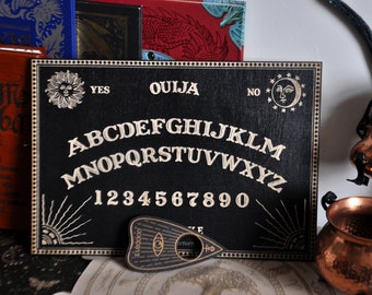 Ouija Spirit Board with planchette. Wooden Board for talking with spirits