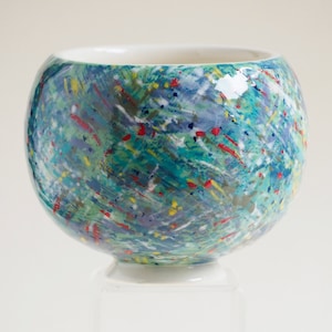 Russell Akerman Ceramic Art hand thrown studio pottery tea bowl. Painted by Russell in an abstract multicolour slipware design.