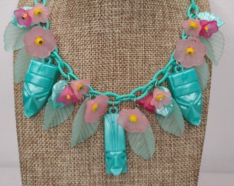 Tiki Necklace with Vintage Tikis, Tropical Flowers, and Leaves in Pink and Aqua. Luau 50s, 60s Retro Pinup Bakelite Lucite Style MCM Kitschy