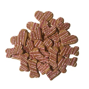 May include: A pile of dog treats in the shape of hearts and bones. The treats are brown with pink and white stripes.
