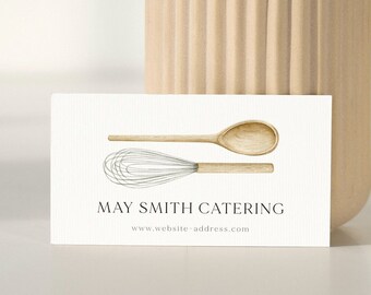 Pode incluir: Cartão de visita branco com uma ilustração de colher de pau e batedor. O texto "MAY SMITH CATERING" e "www.website-address.com" está impresso em preto.