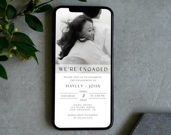 May include: Black and white photo of a couple on a mobile phone screen with a wedding invitation. The invitation reads "We're Engaged" and includes the couple's names, the date, time, and location of the wedding.
