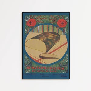 Op de afbeelding: Vintage poster met een blauwe rand met een brood op een gestreept tafelkleed. De poster heeft Franse tekst, rode rozen en bloemmotieven. Het brood is bruin en beige.