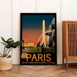 May include: A vintage travel poster advertising Paris, France. The poster features a black and white illustration of a fountain and a tall obelisk in front of a building. The sky is a gradient of orange, pink, and blue. The text on the poster reads "Paris" in gold letters and "Edite par les grands reseaux des chemins de fer francais".