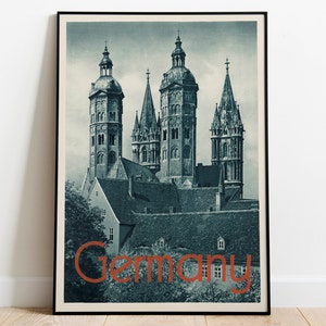 May include: A vintage travel poster featuring a black and white photograph of a cathedral with multiple spires. The text "Germany" is printed in orange at the bottom of the poster.