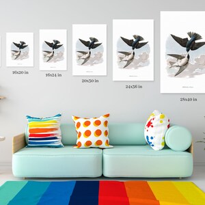 May include: A collection of framed art prints featuring a detailed illustration of two swallows in flight. The prints vary in size, from 12x16 inches to 28x40 inches, and are displayed on a light gray wall above a teal sofa.