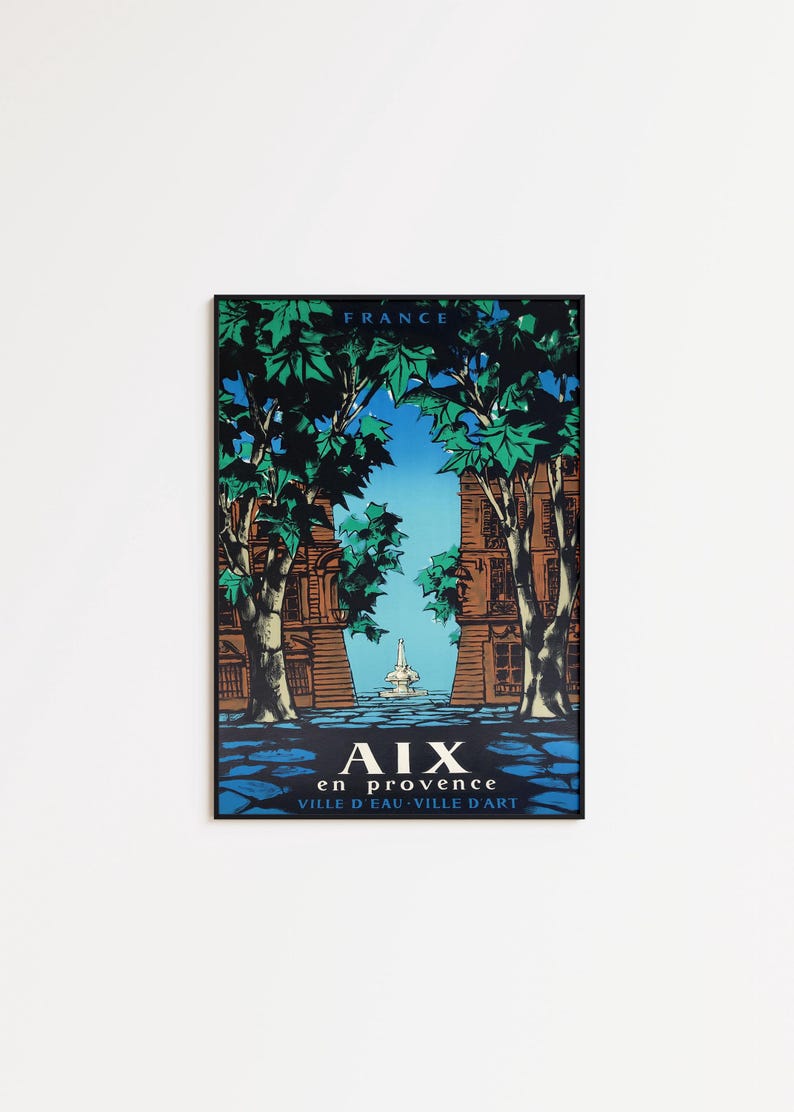 May include: A framed vintage travel poster for Aix-en-Provence, France. The poster shows a stylized illustration of a fountain and buildings framed by trees. The text "AIX en PROVENCE VILLE D'EAU VILLE D'ART" is at the bottom of the poster.